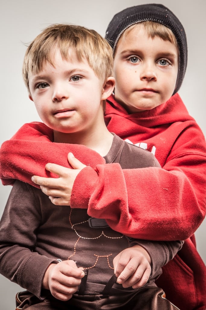 Portrait of two young boys posiing and embracing